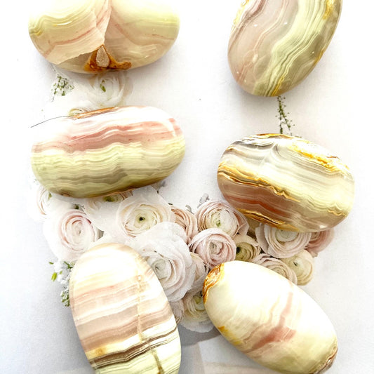 pink banded calcite palm stone crystal