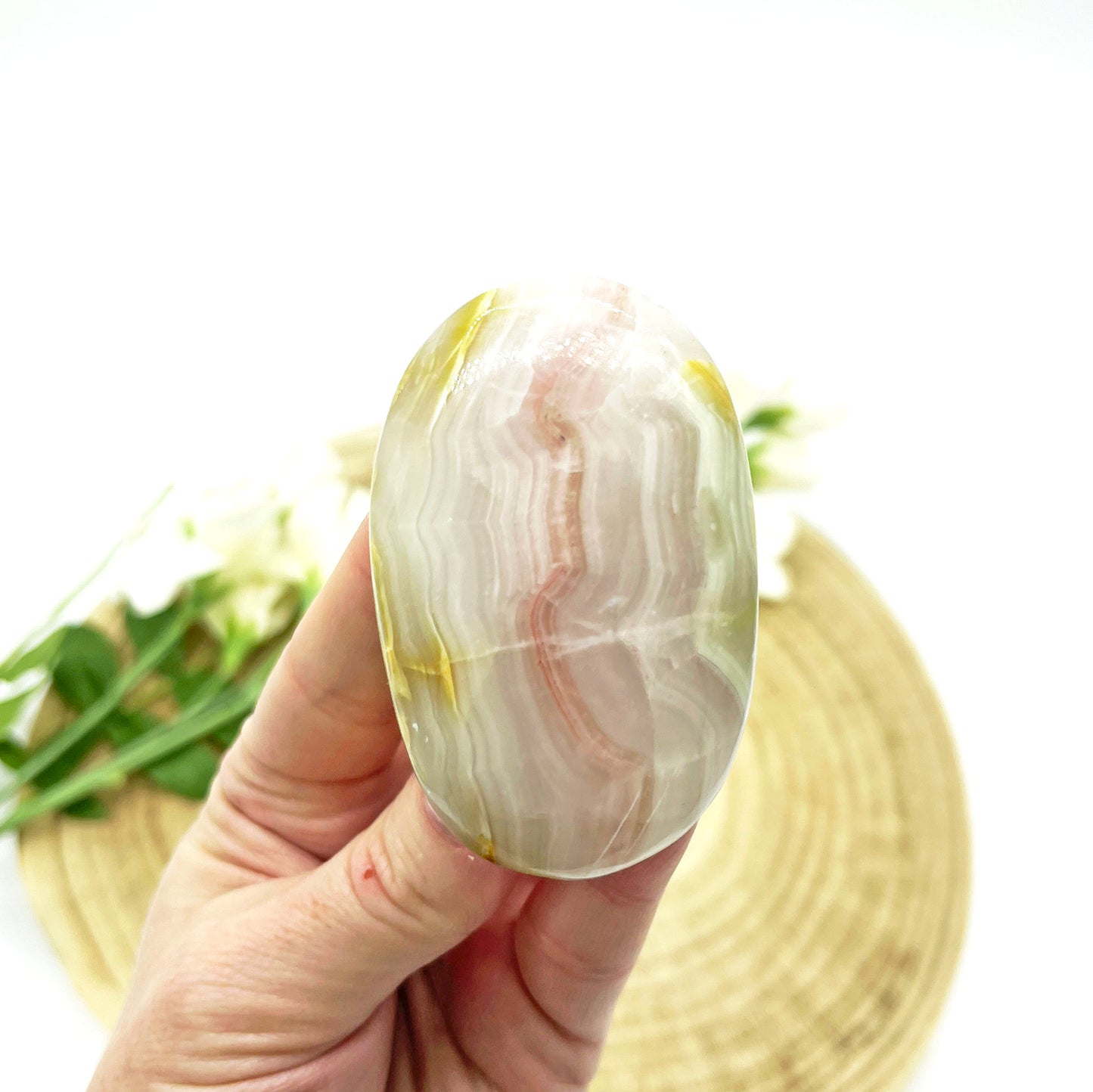 Pink calcite banded palm stone