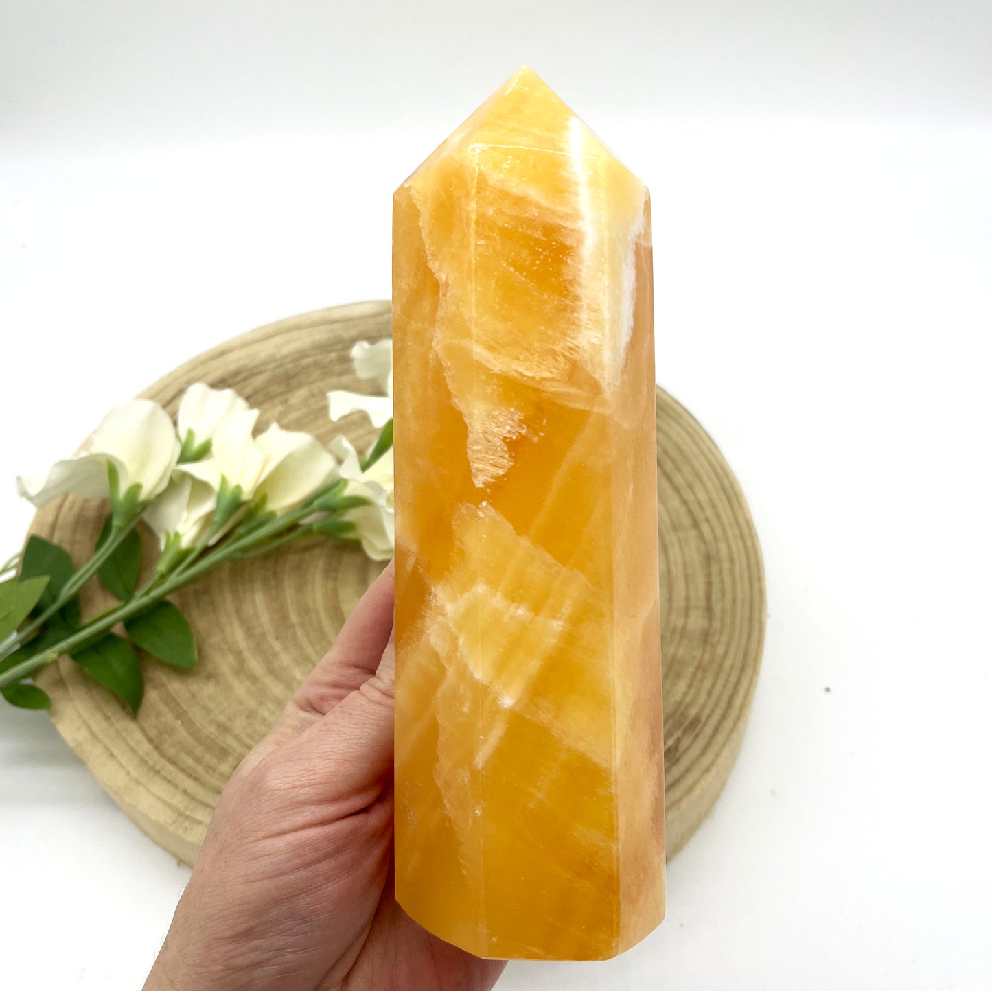 orange calcite generator polished point