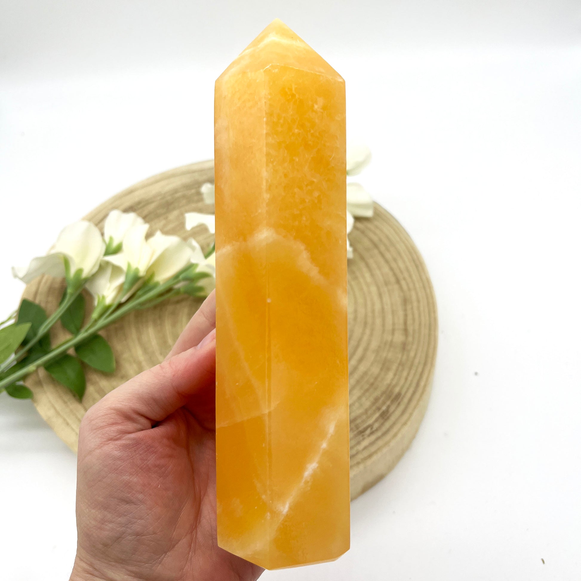 Polished orange calcite generator crystal point