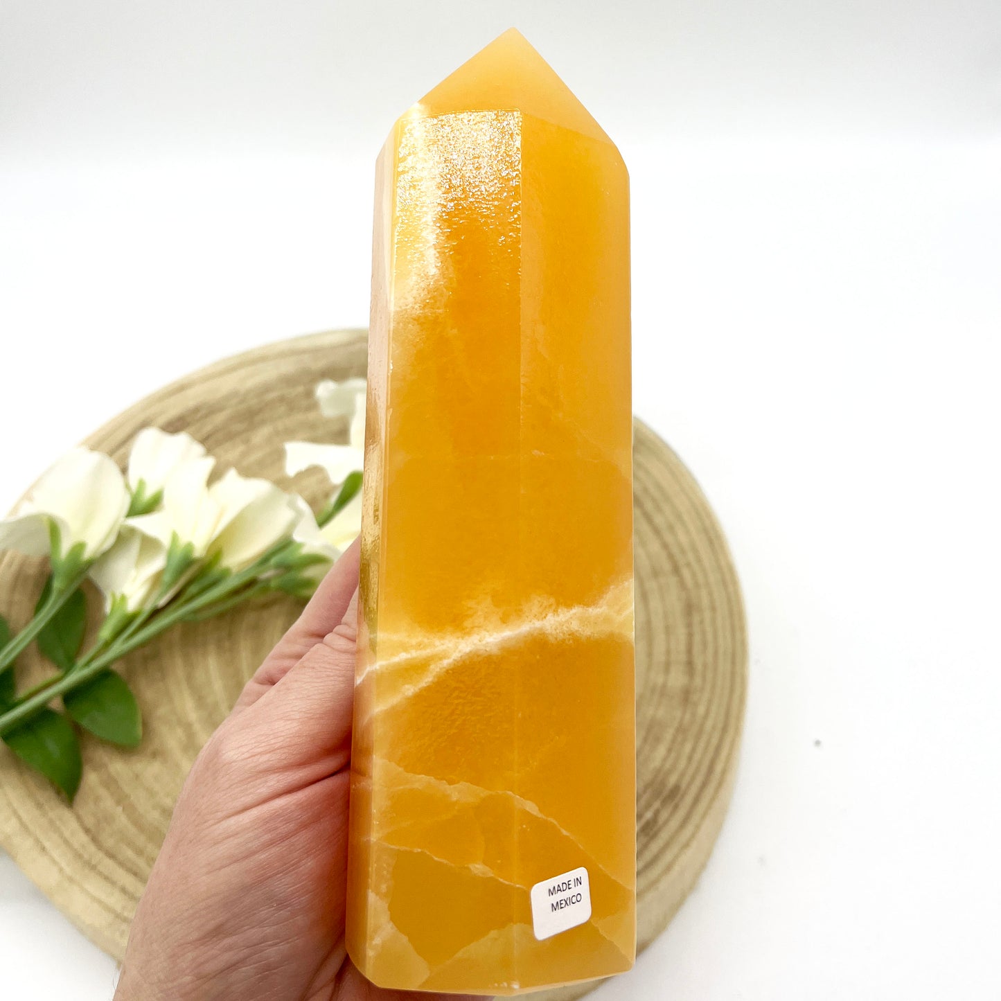 orange calcite crystal point polished generator