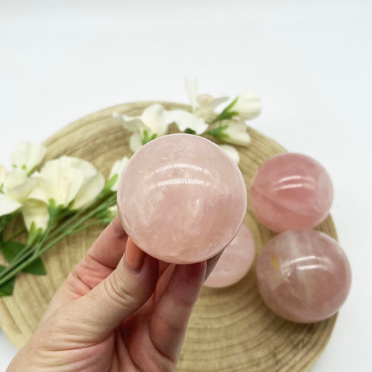 Rose quartz sphere. Polished crystal sphere